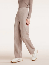 a lady in beige knitted straight leg pants